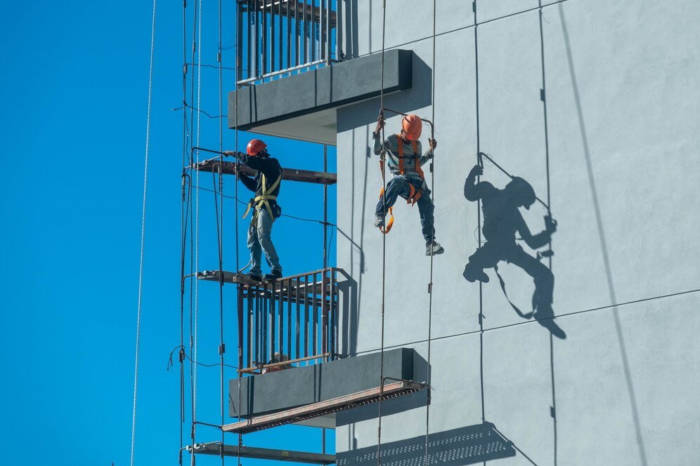 couple workers fixing climbing scaffolding while following all safety measures 181624 46565