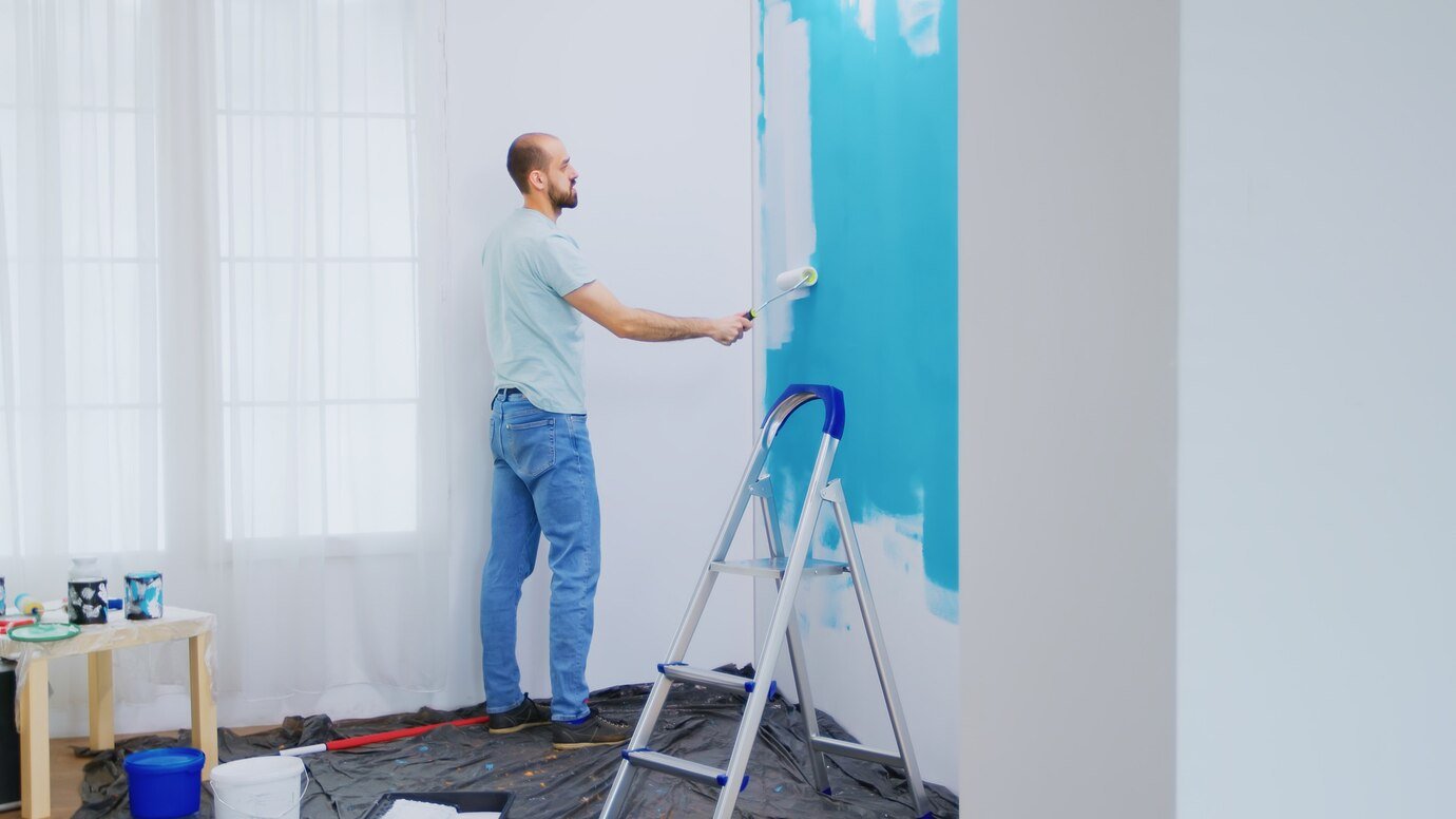 Exterior Painting Services 24 painting apartment wall with white paint using roller brush handyman renovating apartment redecoration home construction while renovating improving repair decorating 482257 14184