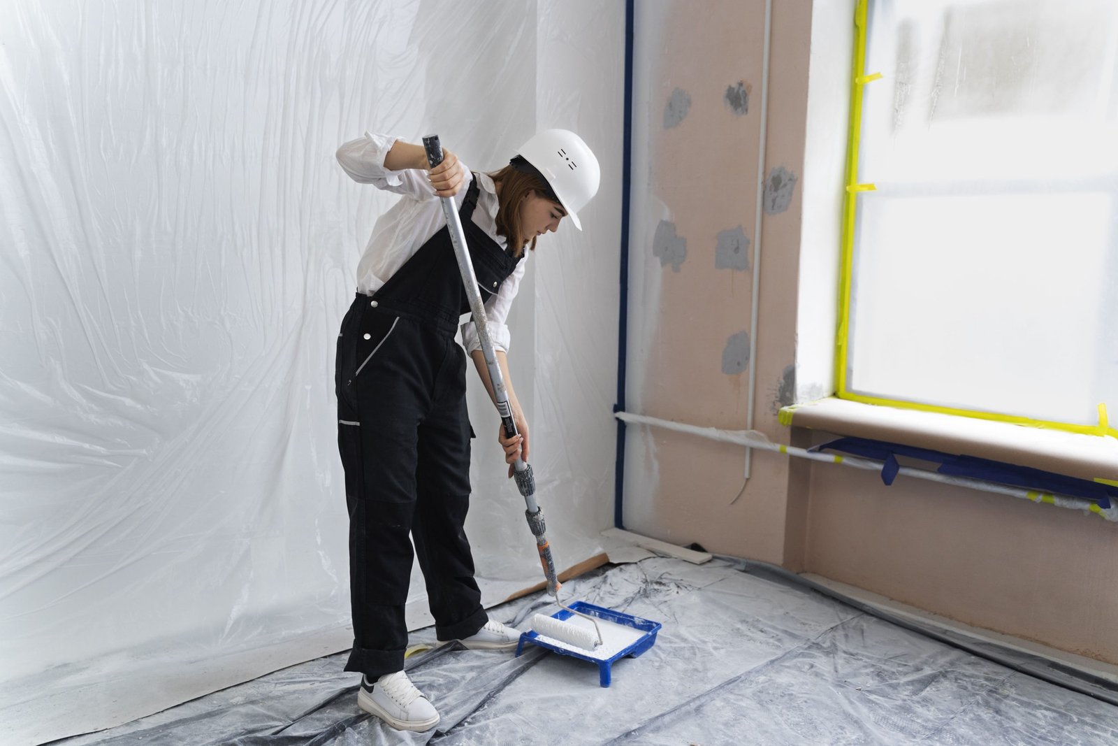 full shot woman working with paint roller min scaled